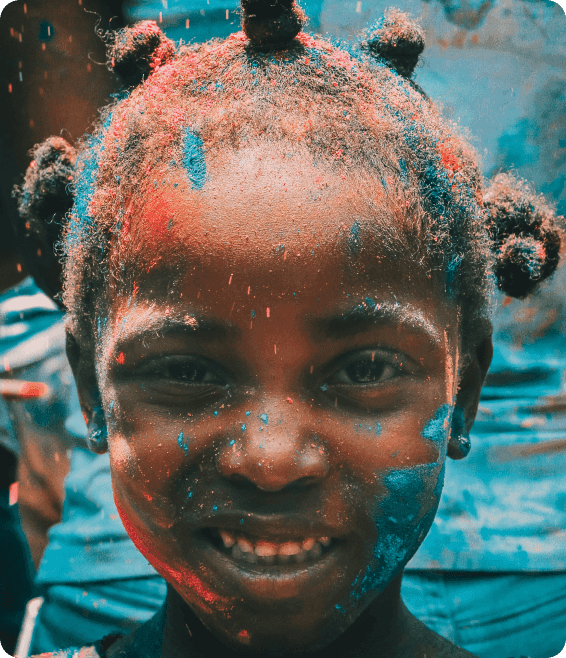 Child with paint on face smiling