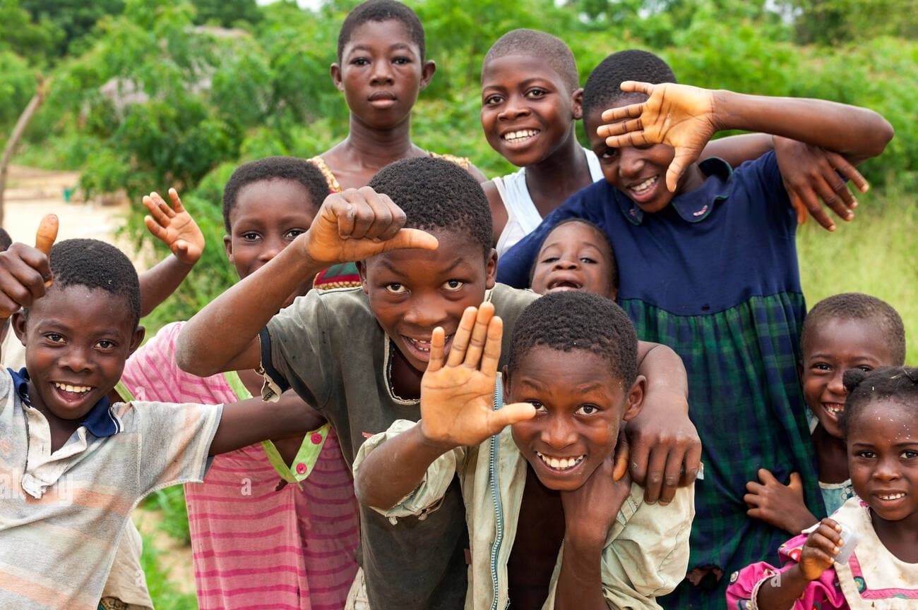 Children with hands up smiling and laughing